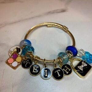 Gold Charm Bracelet with Blue and Black Accents